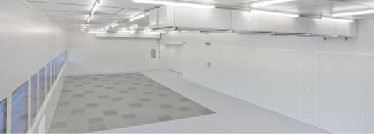 large white room with white ducting on the ceiling